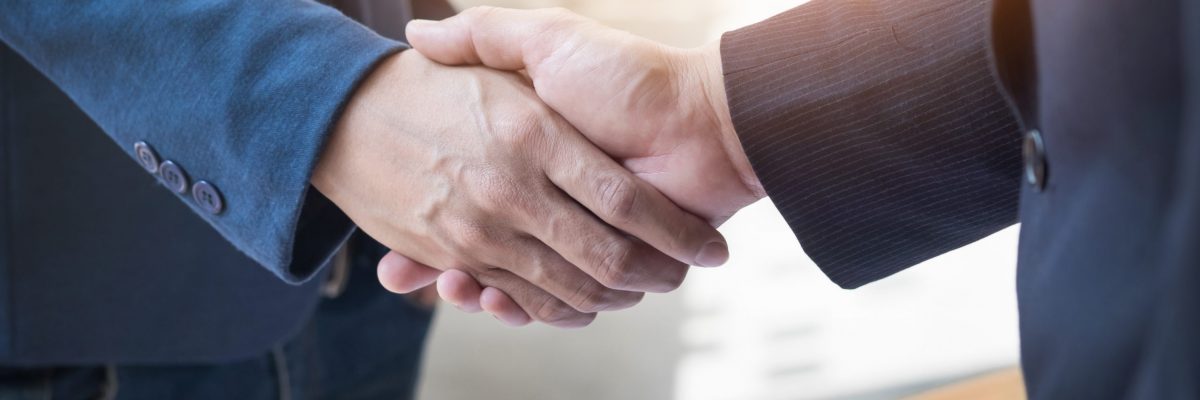 Two confident business man shaking hands during a meeting in the office, success, dealing, greeting and partner concept